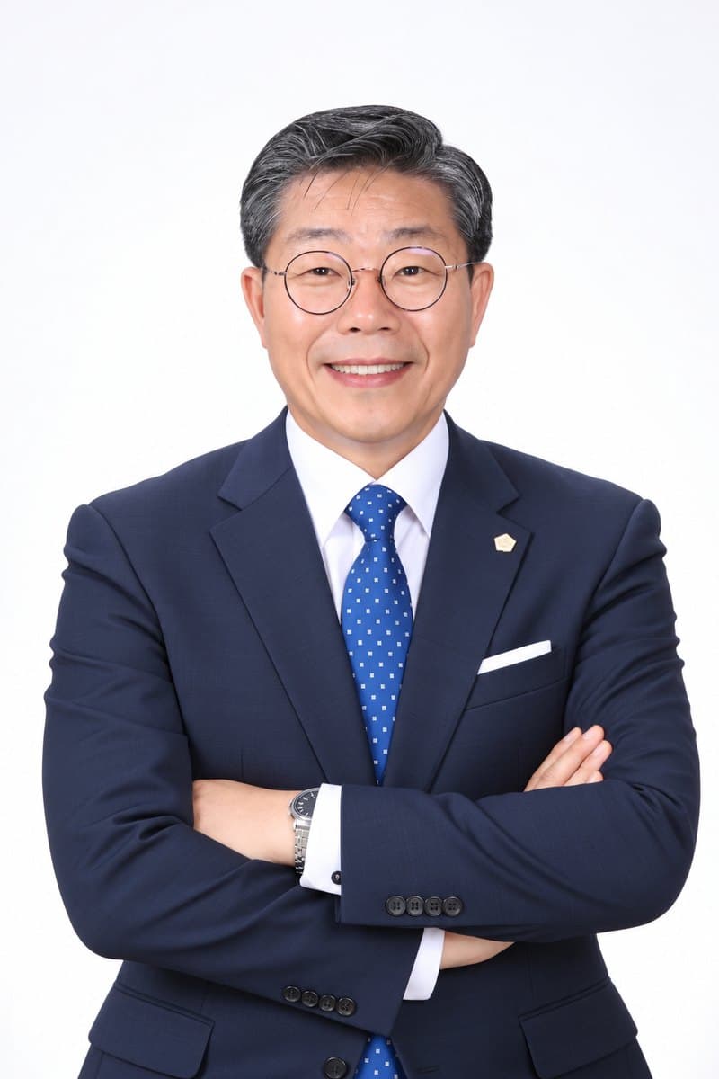 조희창 법무사 프로필 사진. 남색 정장에 팔짱을 끼고 웃고 있다.
